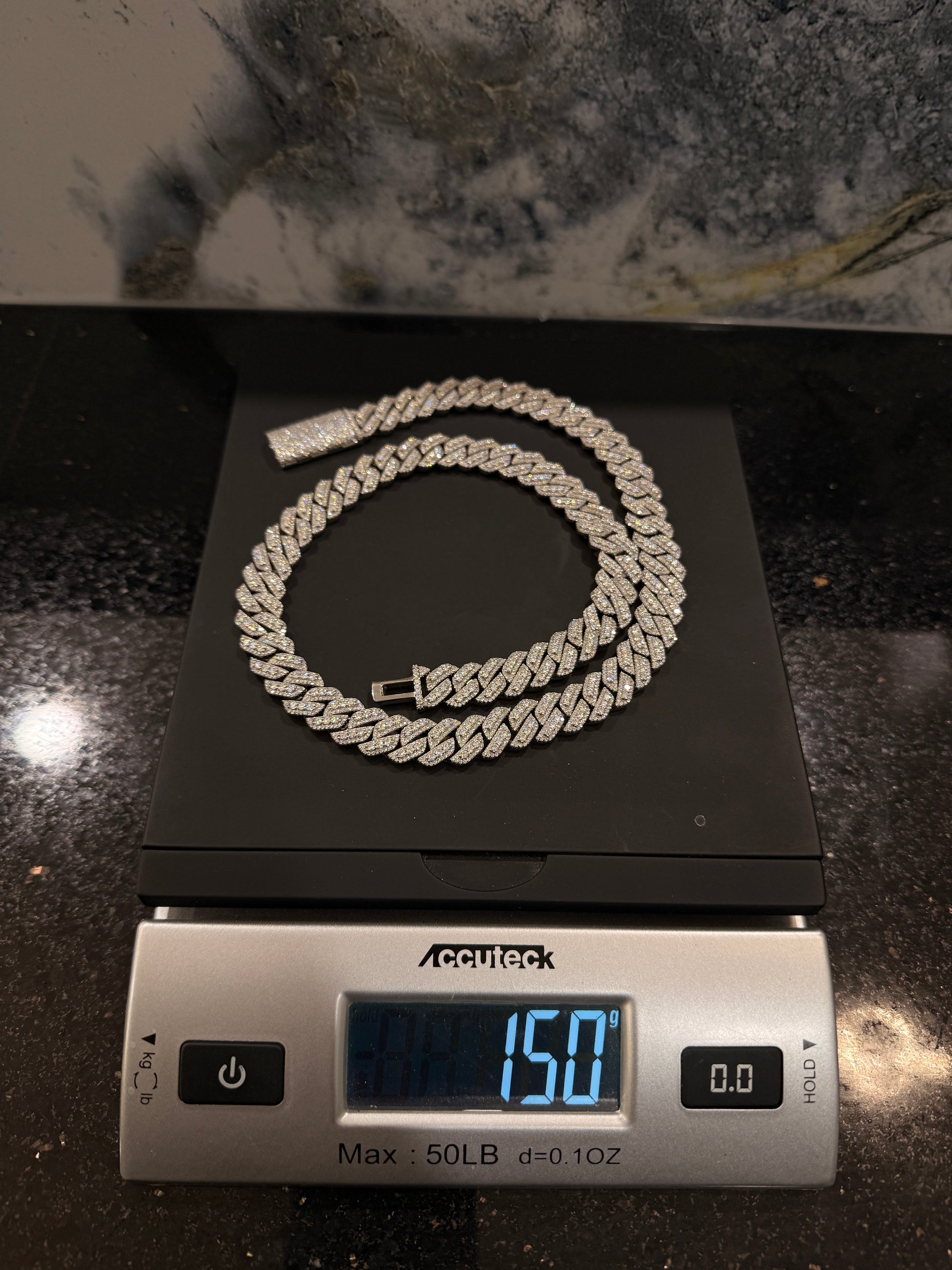 Arvani Monaco 12mm prong-set moissanite Cuban link chain, close-up of prong-set iced links
