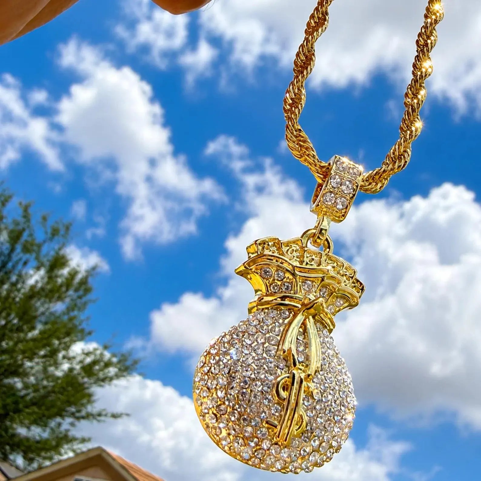 Arvani CZ dollar sign pendant, close-up of iced-out gold plated money symbol